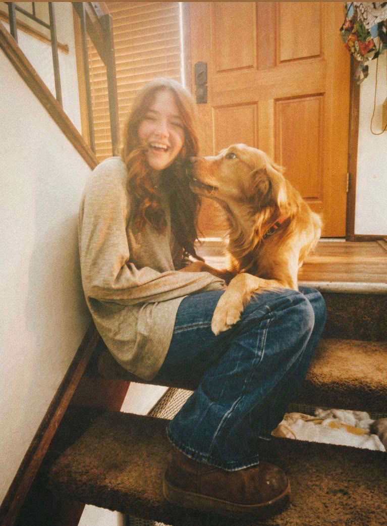 McKenna laughing on the stairs as Chuck gives her a kiss